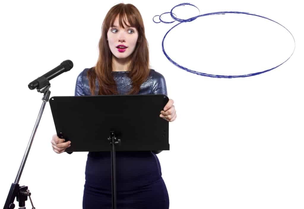 girl in shiny dress speaking on a microphone in a podium on white background