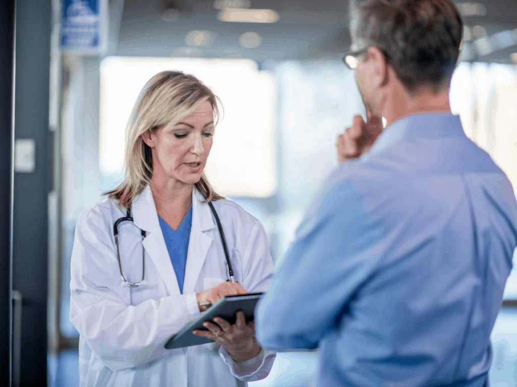doctors standing in hallway discussing medical malpractice complaint