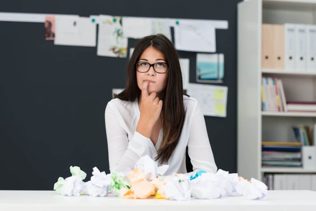 Woman sitting at her desk pondering