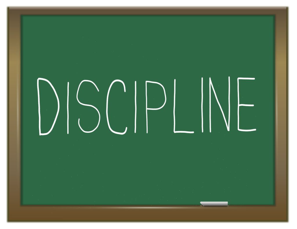 The word discipline written on a chalkboard.