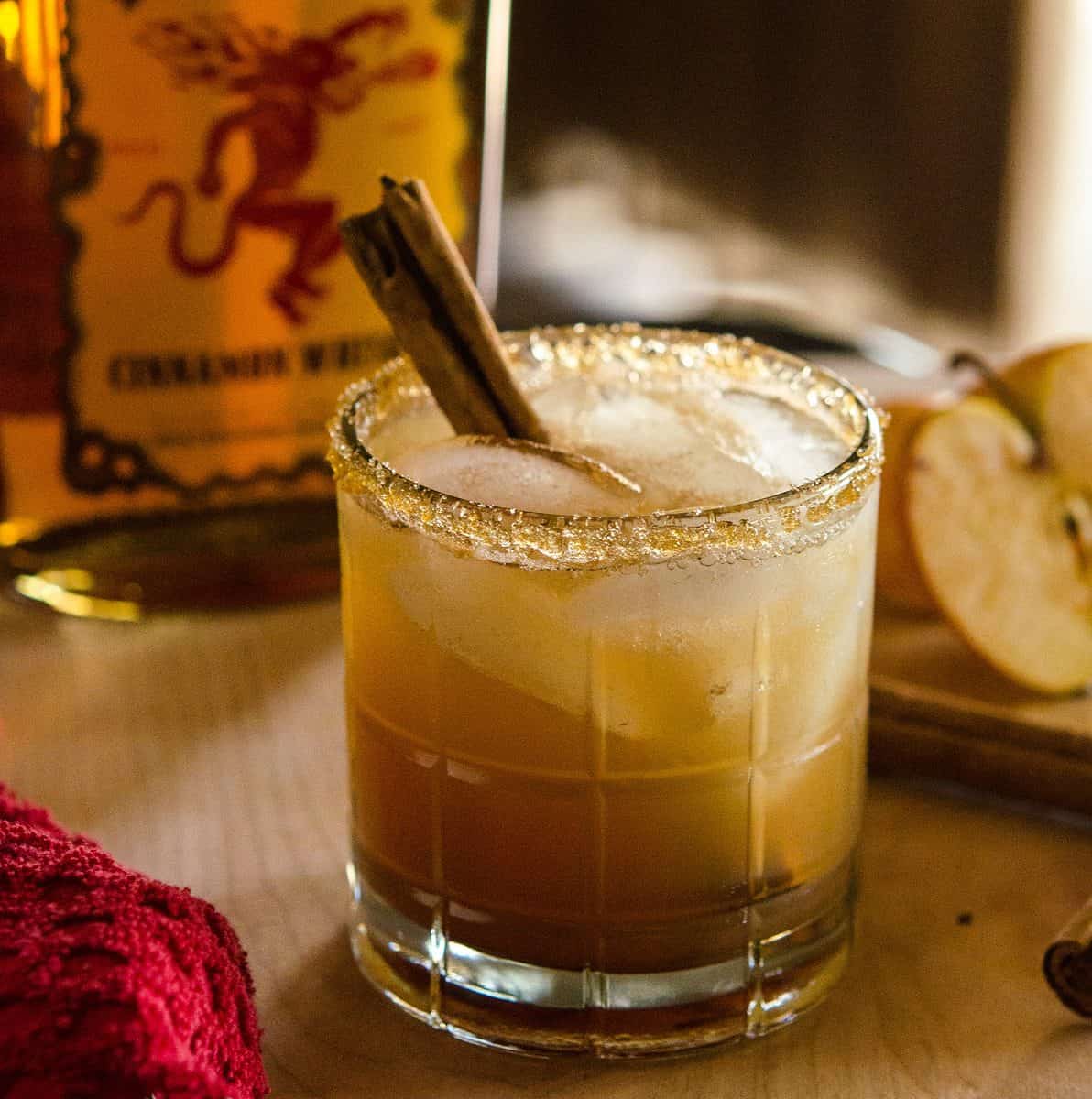 Image of apple juice-based cocktail with cinnamon stick garnish