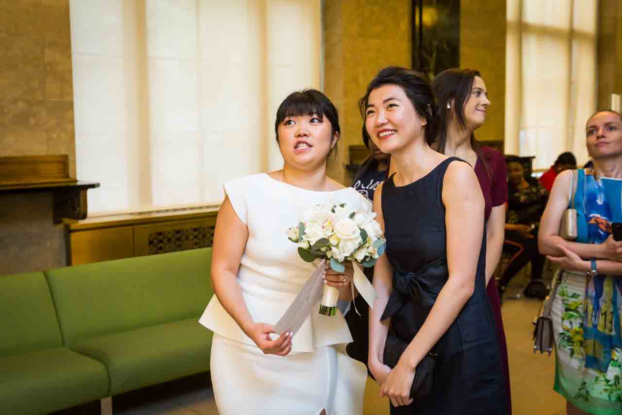 Bride and sister watching for city hall wedding hall wedding to be called