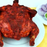 whole chicken tandoori with green chutney and sliced onions