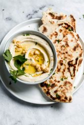 homemade hummus drizzled with olive oil on a plate