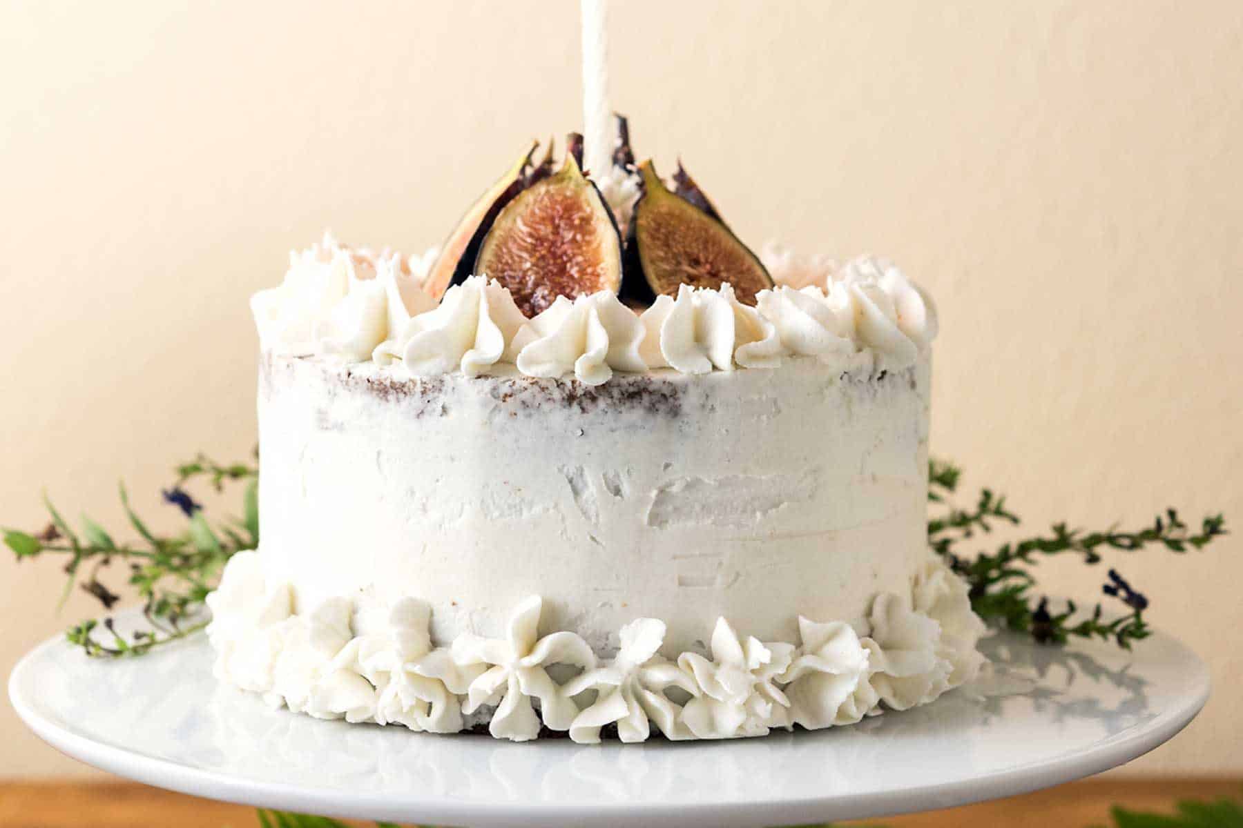 This Caramel Fig Vanilla Layer Cake has gorgeous layers of vegan buttercream, date caramel, and fluffy cake, topped with fresh figs! Soy-free, Dairy-free