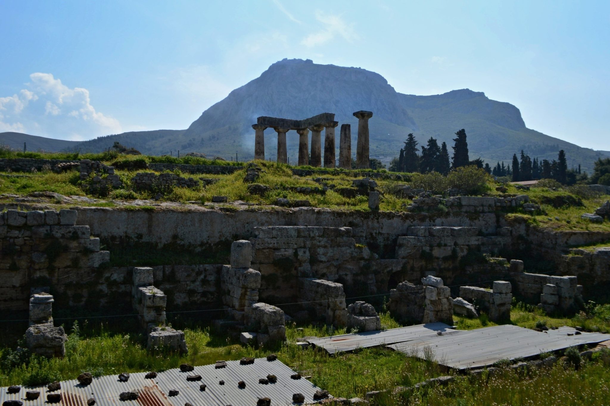 Temple of Apollo with the siluette of Acrocorinth in the background.