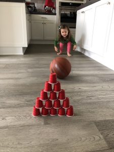 roll bowling ball to plastic cups