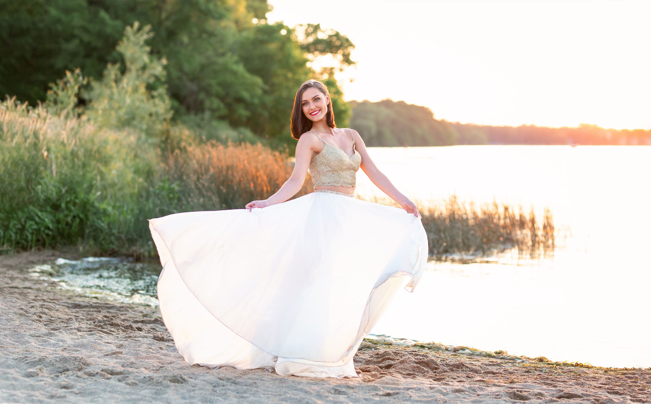 KidrowskiCreativeTheisen Girl in formal dress twirling by lake