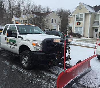 snow plowing LandworkContractors pickup truck