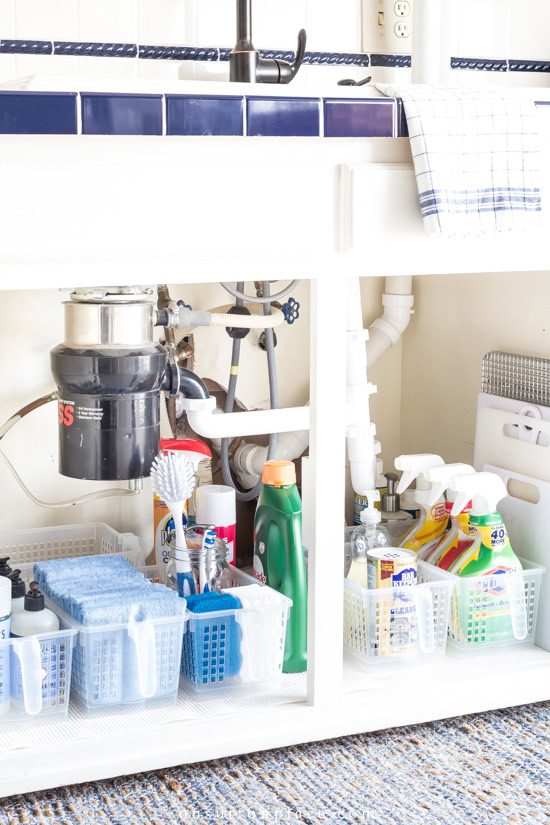 cleaning products and cutting boards under kitchen sink