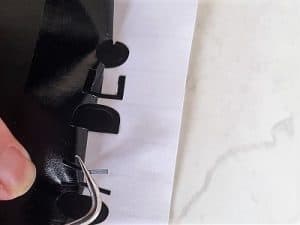 Helping the letters separate from the vinyl with the Cricut tool