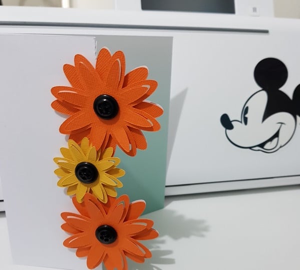 3D tri-fold flower card in front of the Brother Disney Scan N Cut cutting machine.