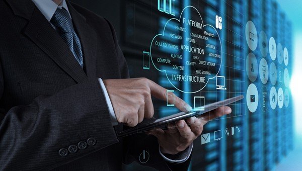 About GB Hosting an Esthetig company. Offering hosting and domain names at sensible prices. Image shows a bank of servers with a blue filter going from left to right back, infront of the servers are various icons related to hosting, with a man in a suit and tie (chest and arms only) using a tablet, above the tablet is a line drawing of a cloud with various words and icons related to hosting