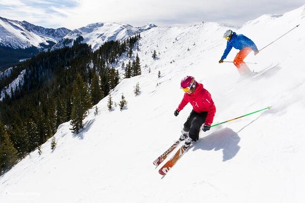 Skiers skiing down Hildalgo run off of Highline Ridge at Taos Ski Valley, New Mexico Skiers skiing down Hildalgo run off of Highline Ridge at Taos Ski Valley, New Mexico