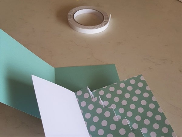 Double sided tape with the front and back section of the Step Card