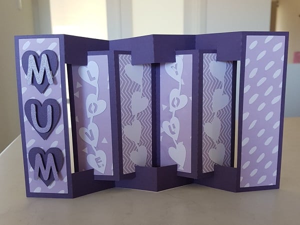 Concertina card with embellishments placed on the panels
