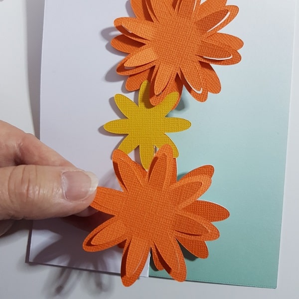 Each layer of the flowers being added to the 3D flower tri-fold card