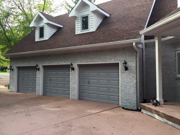 home exterior look with color-washed grayish brick walls and fossil gray doors