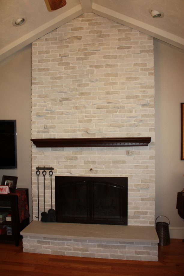 after makeover whitewashed traditional floor to ceiling brick fireplace with black insert with cover