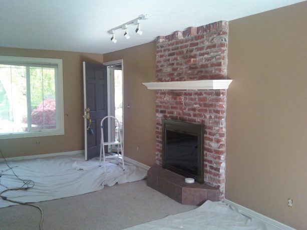 before makeover floor to ceiling red brick fireplace with white mantel shelf