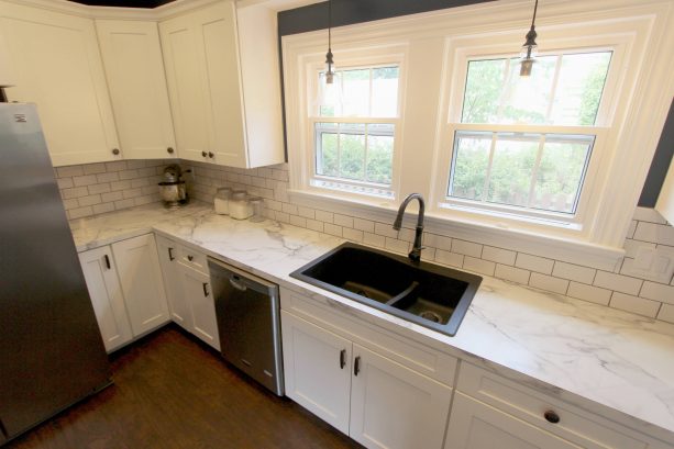 kitchen with antique white cabinets and laminate countertops with white granite look