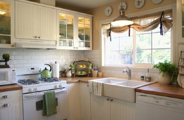traditional farmhouse kitchen with antique white cabinets and butcher block countertops