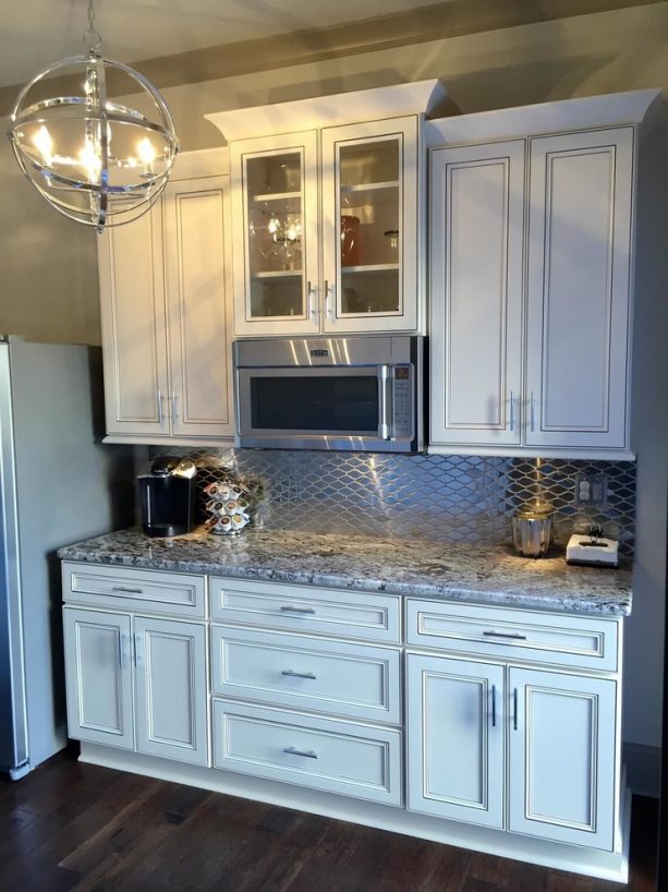 traditional kitchen with antique white cabinets and tubular metal bar pulls