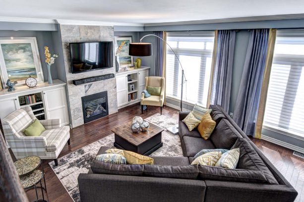 a slightly cheerful living room with grey, mustard, and green colors