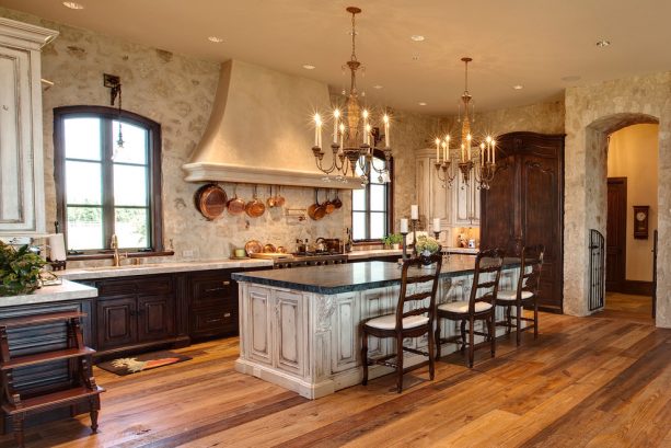 off-white kitchen cabinets paired with a natural stone wall