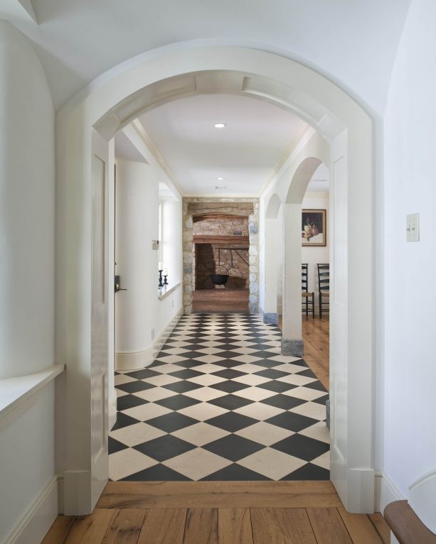 the combination between black and white checkered marble floor and hardwood
