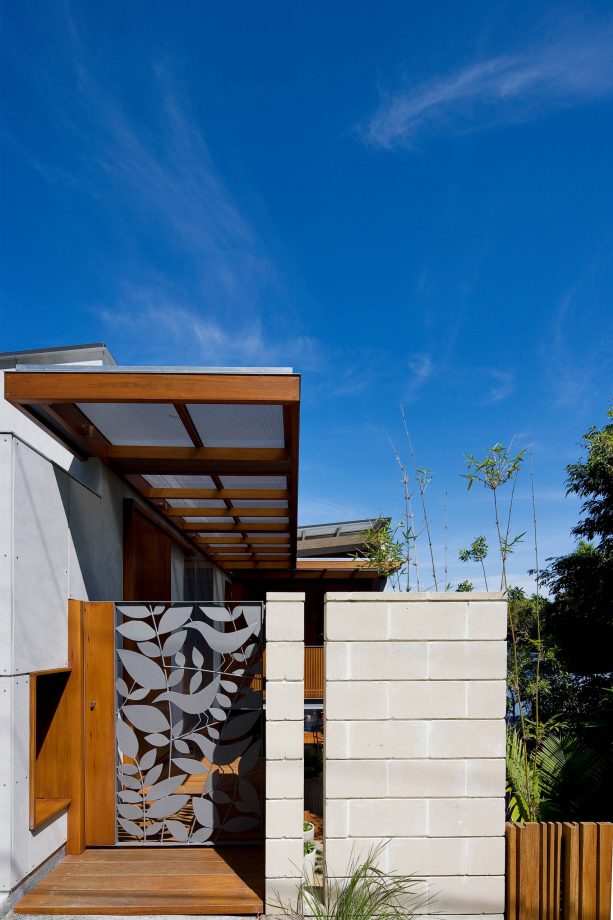 a glass gate paired with cinder block and wood porch fencing