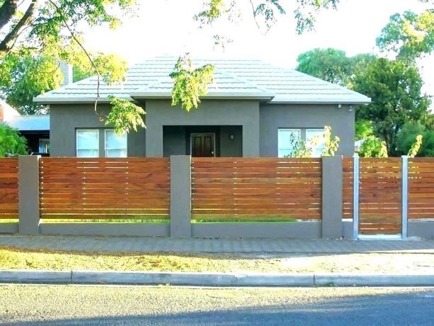 concrete-finished cinder block base and posts for horizontal wooden fence