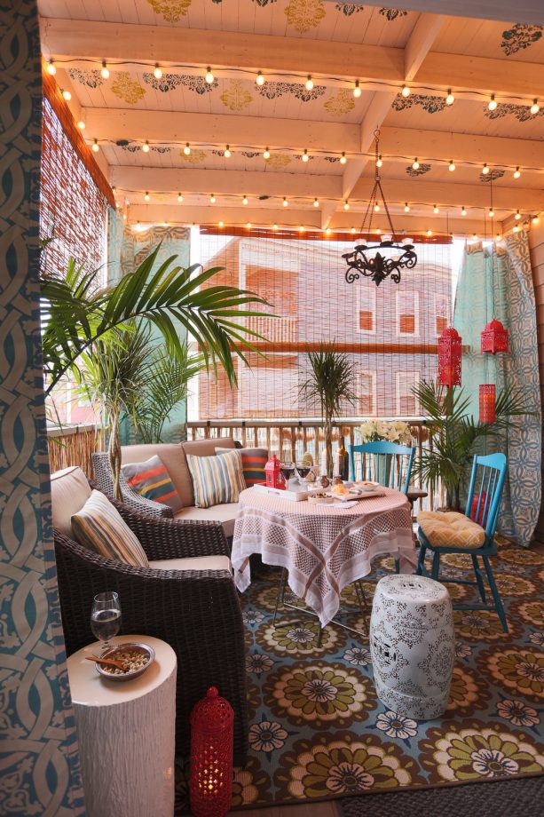 a balcony with bamboo blinds and cozy seats