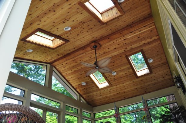 a traditional porch with the combination of glass panels and T&G ceiling from stained cedar material