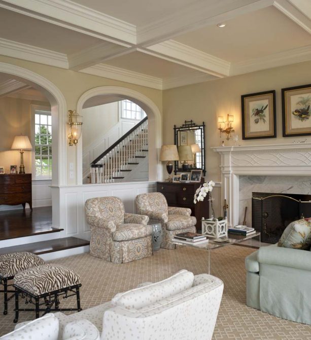 a half wall with columns separating the traditional living room and the hallway