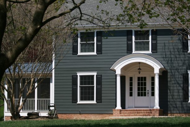 an elegant traditional exterior with dark gray, white, and black color scheme