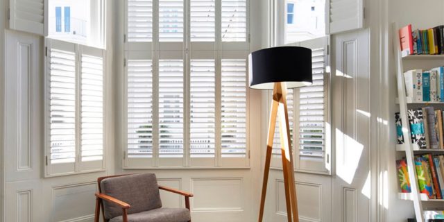 Tier-on-tier shutters fitted to a living room sash window in Brighton & Hove