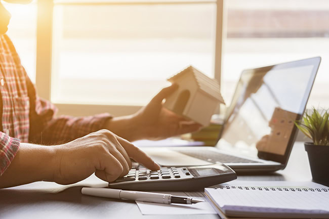 photo of a man calculating his finances after a spousal buyout with Krista Rumberg, an Edmonton area mortgage broker specializing in helping divorcing couples separate their property with the help of a spousal buyout program that can unlock up to 95% of a home's equity