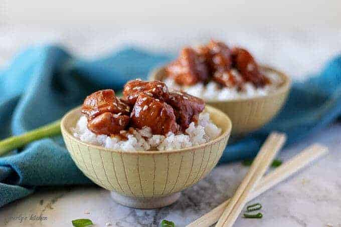 The finished Mongolian chicken in yellow bowls served over white rice.