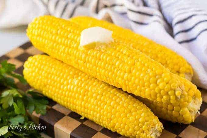 Four ears of Instant Pot corn, topped with melting butter.