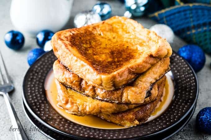 Four pieces of eggnog French toast drizzled with maple syrup.