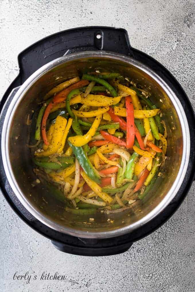 Bell peppers, onions, and garlic sauteing in the Instant Pot.