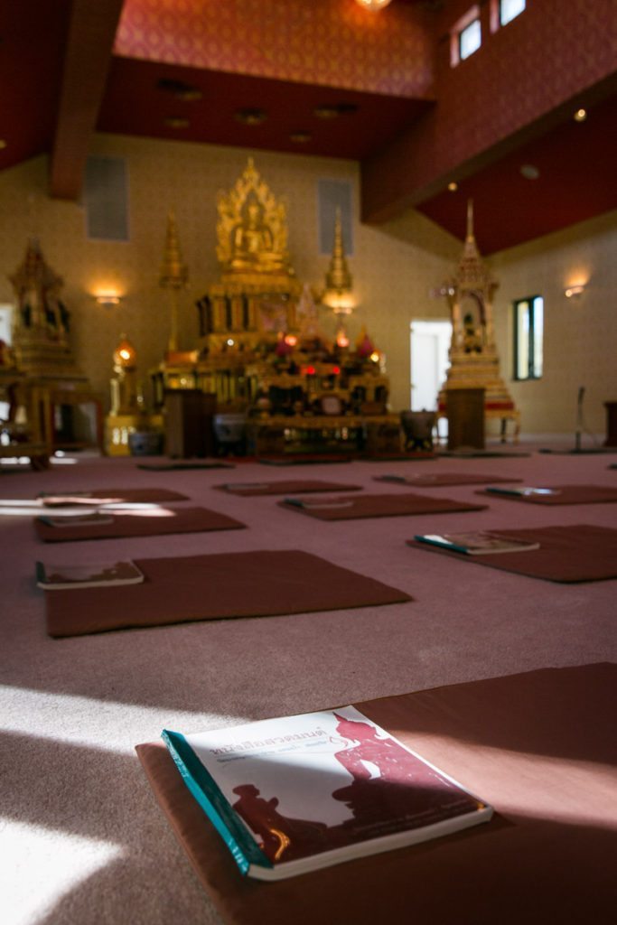 Worship guides at the Wat Mongkolratanaram, photographed by NYC photojournalist, Kelly Williams