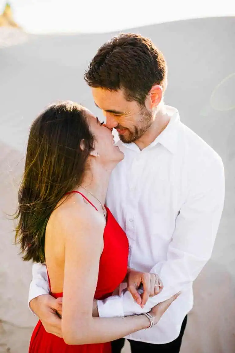 Engagement kisses in the sand