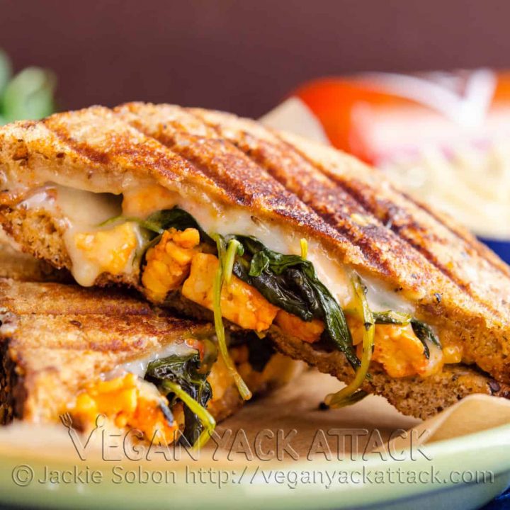 An nontraditional Grilled Buffalo Tempeh Mozzarella Sandwich, complete with spicy tempeh, kale, and melty vegan mozzarella.