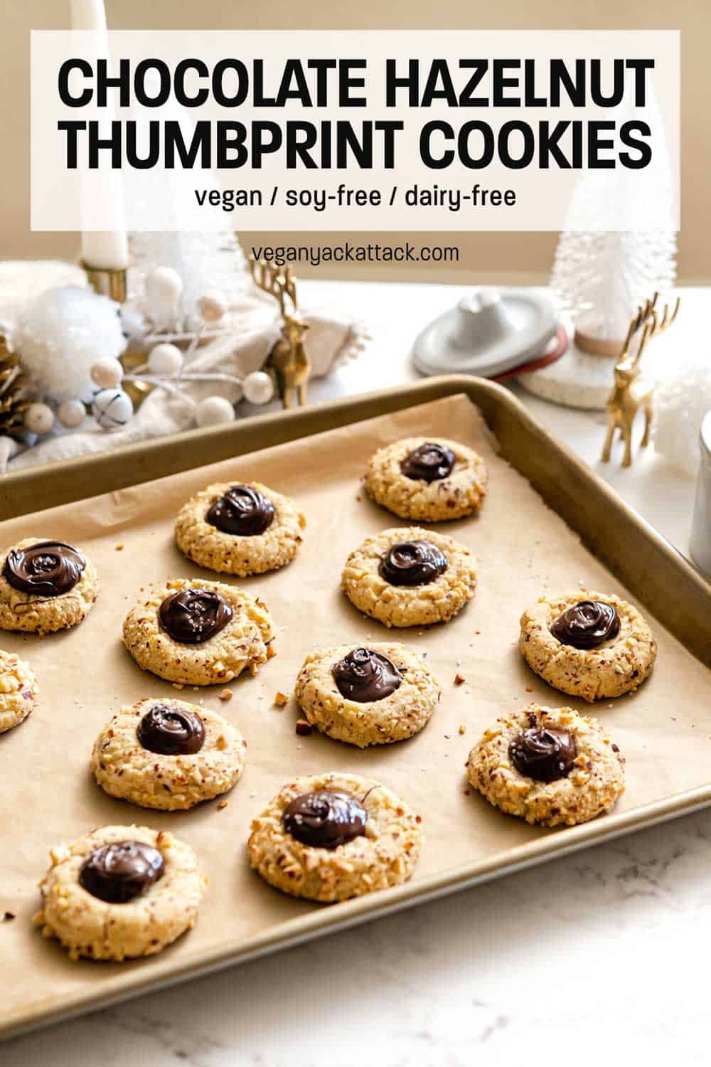 Sheet pan filled with chocolate hazelnut thumbprint cookies, and various Christmas decor