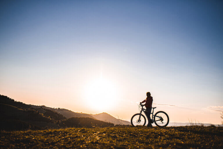 Woman riding her electric bicycle outdoors