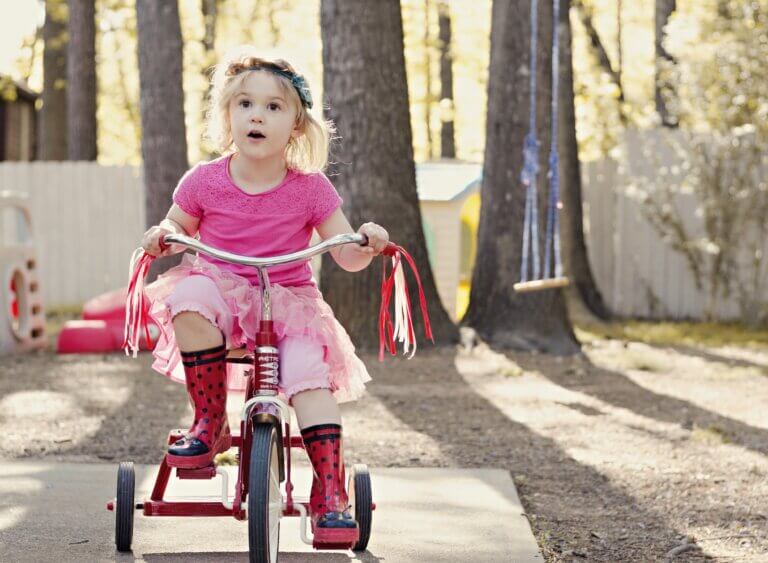 Little girl riding a tricycle