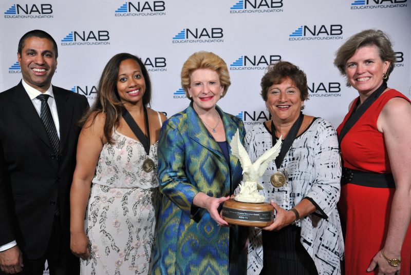 A participant receives a life time achievement award during this Miami red carpet photography event.