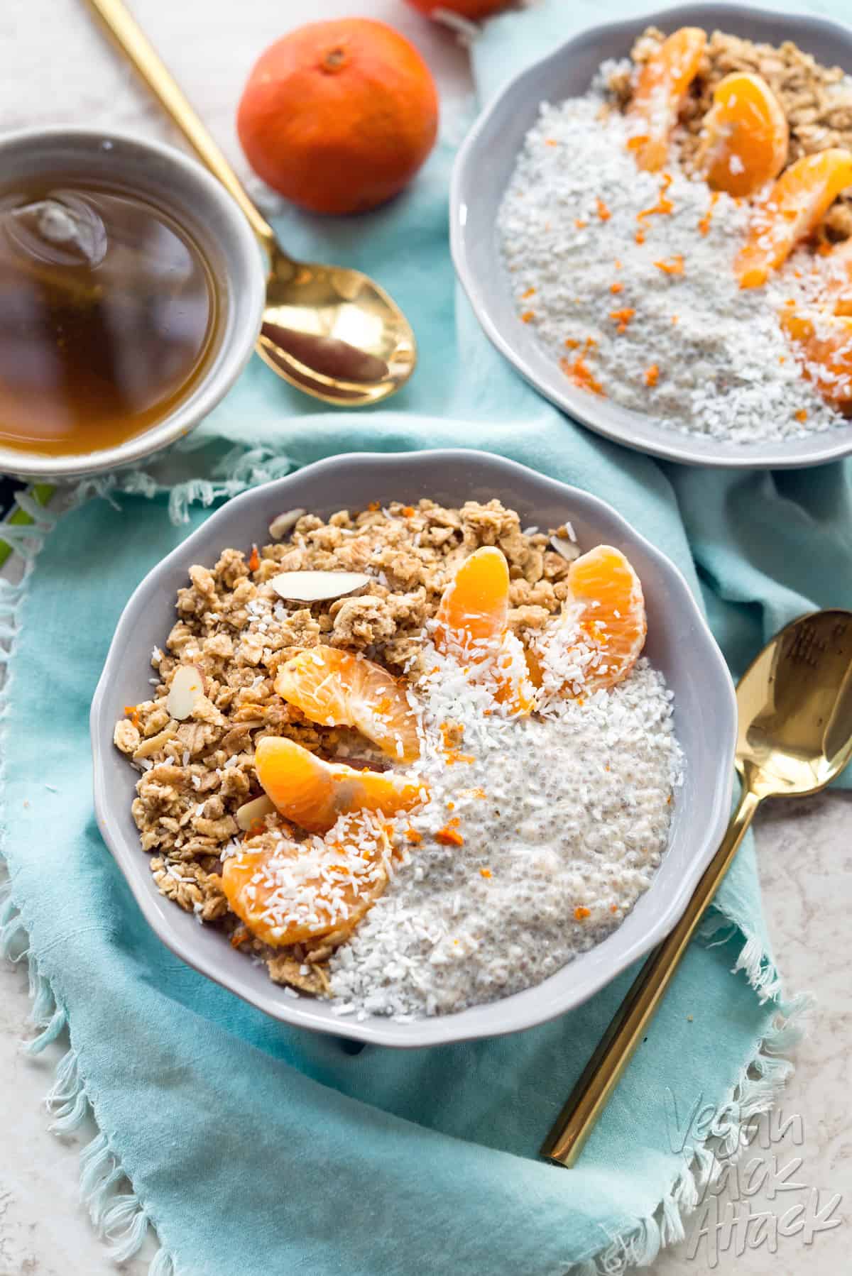 dreamy tangerine chia pudding with granola in a lilac-colored bowl with teal linen